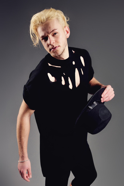 Male Model blond in hat posing in studio - Foto, afbeelding