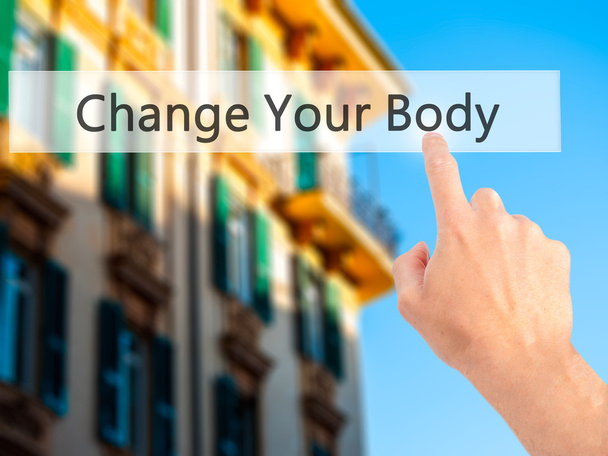 Cambiar su cuerpo - Mano presionando un botón sobre fondo borroso
  - Foto, Imagen