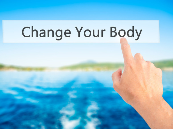 Cambiar su cuerpo - Mano presionando un botón sobre fondo borroso
  - Foto, Imagen