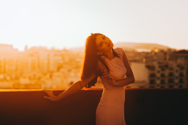 brunette woman in a white evening dress - Fotoğraf, Görsel