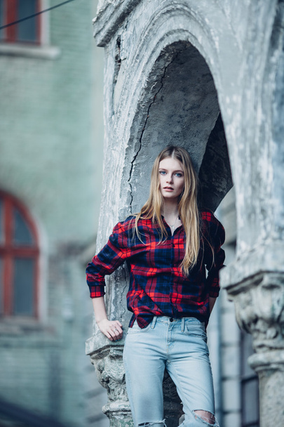 Blonde pretty girl standing in front of building - Фото, изображение