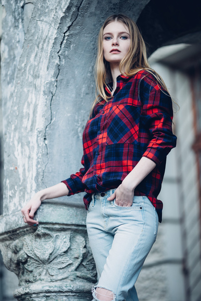 Blonde pretty girl standing in front of building - 写真・画像