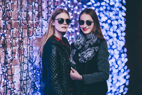 two girls standing on the street with blue bokeh - Φωτογραφία, εικόνα