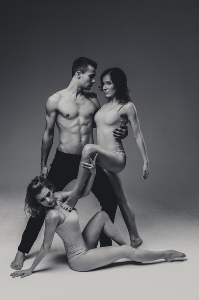 Acrobats man and two women  - Фото, изображение