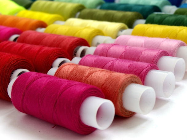colored threads and needles for sewing equipment - Foto, imagen