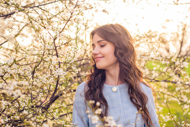 beautiful happy female in blossom. Spring concept - Photo, image