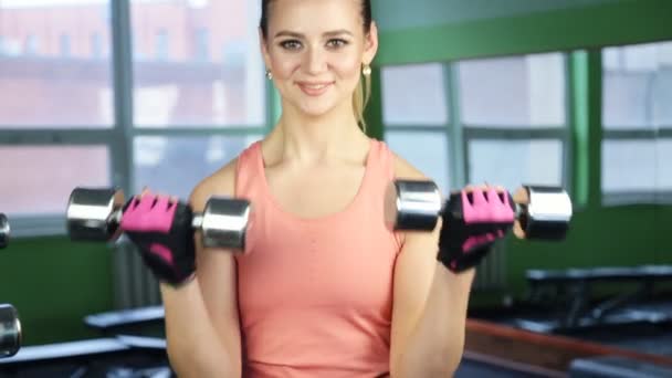 The woman with dumbbells in sports club - Footage, Video