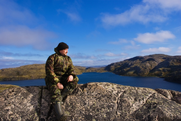 Man sits on a mountain top. Ridge Musta Tunturi. - Photo, Image