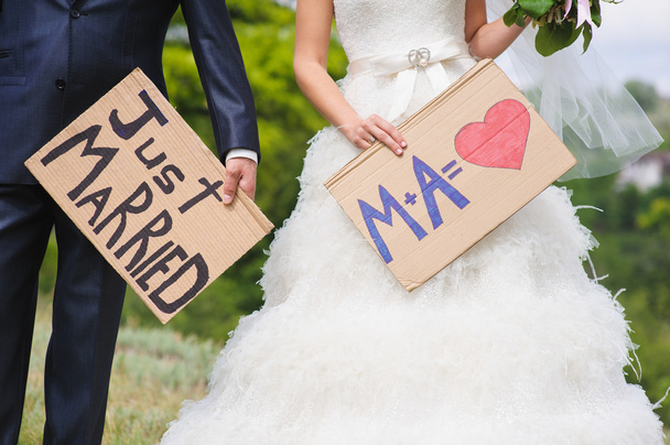 bride and groom with just a married signs - Photo, Image