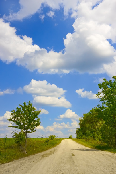 Cloudscape over rural road - Photo, Image