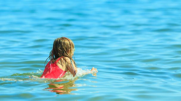 Little girl kid swimming in sea water. Fun - Фото, зображення