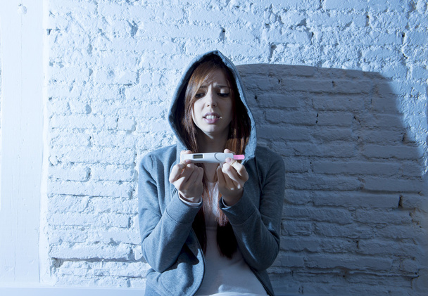 young teenager girl or young woman in shock scared after positive pregnancy test - Foto, imagen