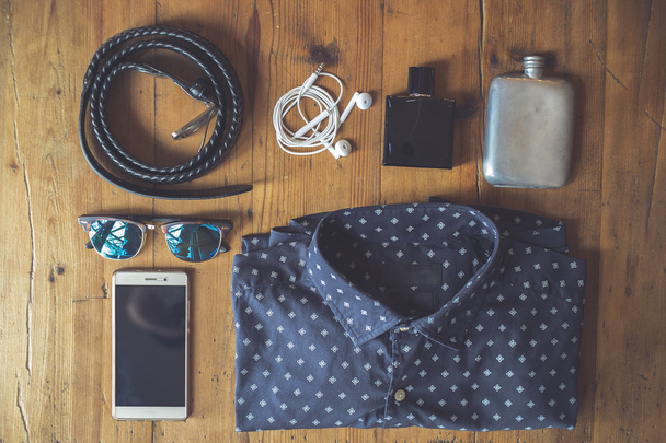 Aerial view of clothing and essentials for traveling light over a wooden board - Photo, Image