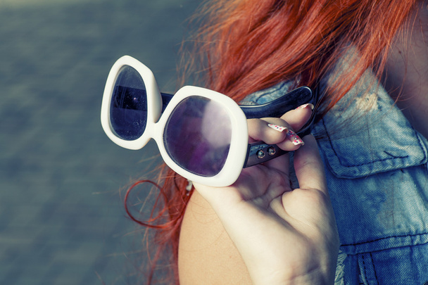 Sunglasses in female hand - Fotó, kép