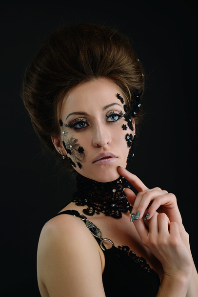 woman black lace flowers on face - 写真・画像
