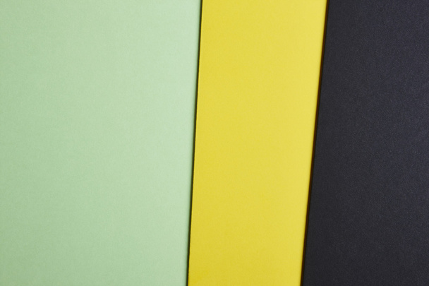 Colored cardboards background in green yellow black tone. Copy s - Фото, зображення