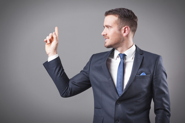 Handsome smiling business man pointing  - 写真・画像