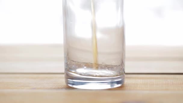 lemonade or soda drink pouring into glass on table - Video, Çekim