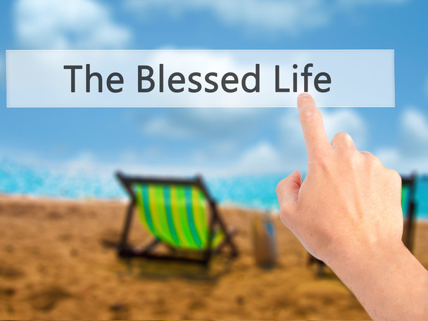 The Blessed Life - Hand pressing a button on blurred background  - Photo, Image