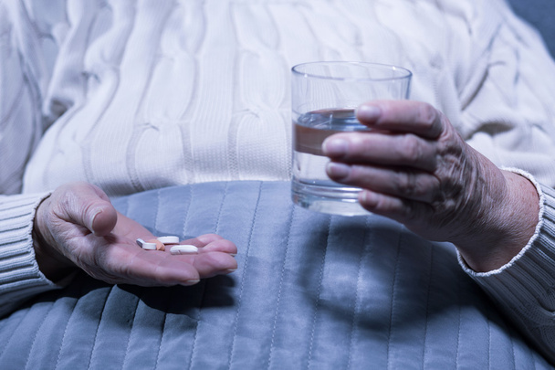 Taking her medication every day - 写真・画像