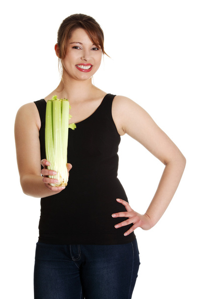 Young woman with celery - Фото, зображення