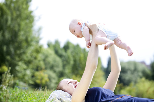 Mother and her little son outdoors session  - 写真・画像