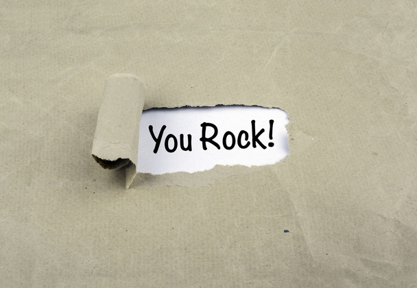 Inscriptie onthuld op oud papier - You Rock! - Foto, afbeelding