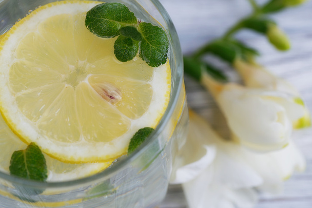 Lemonade with fresh lemon on wooden background  - Φωτογραφία, εικόνα