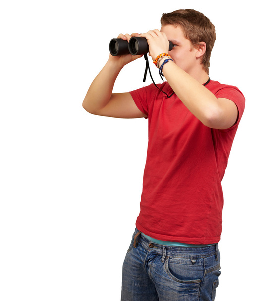 Portrait of young man looking through a binoculars over white ba - Photo, Image