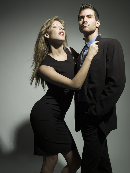 elegant fashionable couple in black suit and dress - Fotó, kép