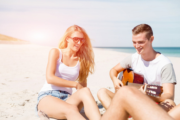 Beautiful young people with guitar on beach - Foto, immagini