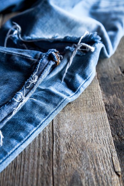 jeans on a wooden background. Fashion, clothing, lifestyle. - Foto, afbeelding