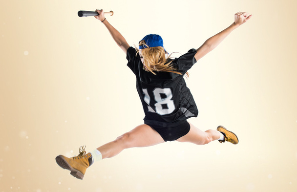 Woman jumping and playing baseball - Fotoğraf, Görsel