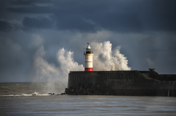 Large sea waves crashing over lighthouse during storm with beaut - Photo, Image