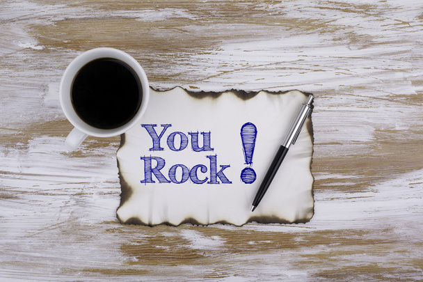 On the table a piece of paper and text - You rock! - Photo, Image