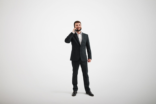 Businessman in a formal wear talking by phone - Фото, изображение