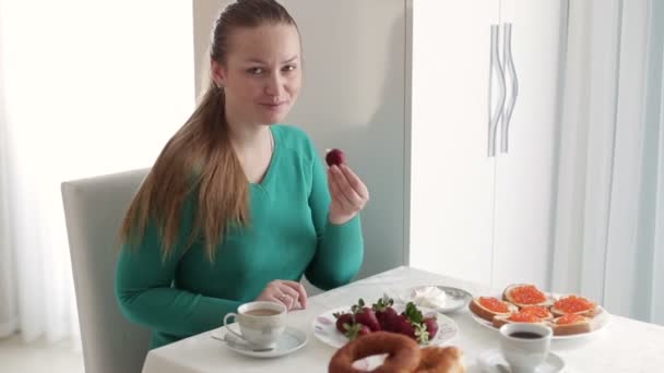 Beautiful young Woman sitting by the window on the breakfast. Close-up.  HD 1920x1080 - Záběry, video