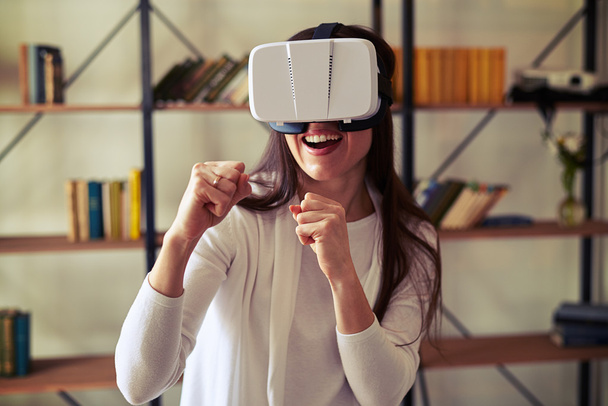 Woman fighting with someone wearing virtual reality glasses - Photo, Image