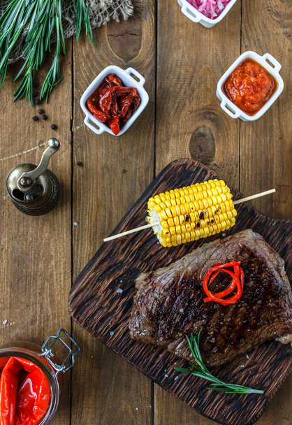 Tender, juicy veal steak medium rare with corn and sauces. Top view - Fotoğraf, Görsel