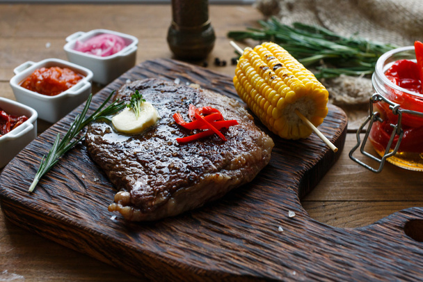 Смачний яловичий стейк на дерев'яному столі, крупним планом
 - Фото, зображення