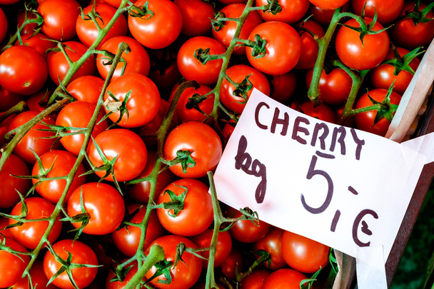 Close-up detail view of cherry tomatoes and price tag - Photo, Image