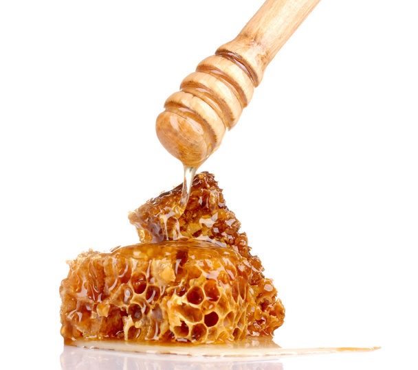 Tasty honeycombs and wooden drizzler isolated on white - 写真・画像