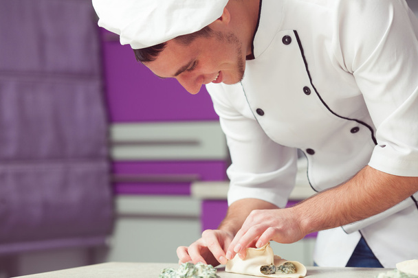 Vegetarian bakery concept. Smiling chef cook in uniform working - Zdjęcie, obraz