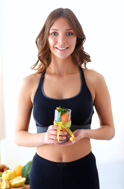 Portrait of a pretty woman holding glass with tasty juice - Foto, imagen