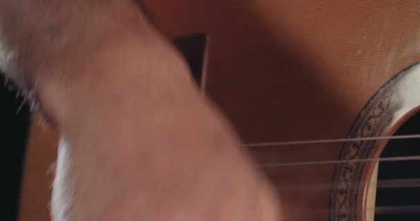Musician playing acoustic guitar in a recording studio - Video