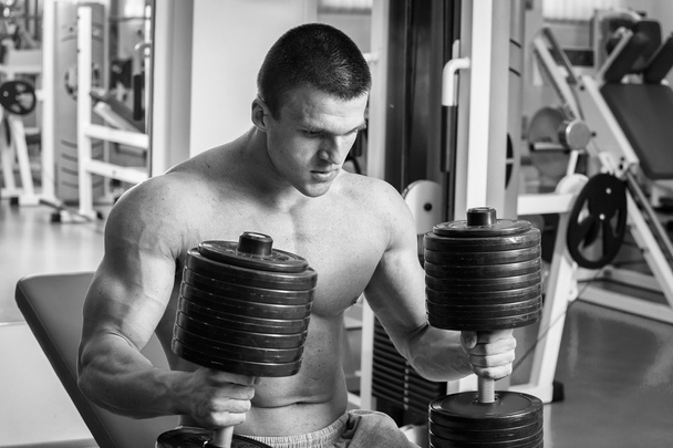 Strong man. Muscle training in the gym. Training in the gym. - Photo, Image