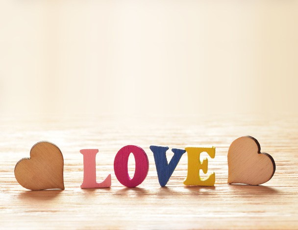 Hearts on wooden background with letters love - Photo, Image