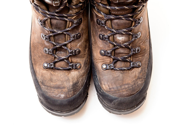 Old scuffed hiking boots isolated on white background - Photo, Image