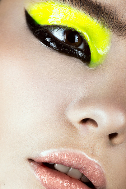 Close-up portrait of girl with yellow and black make-up creative art. Beauty face. - Φωτογραφία, εικόνα