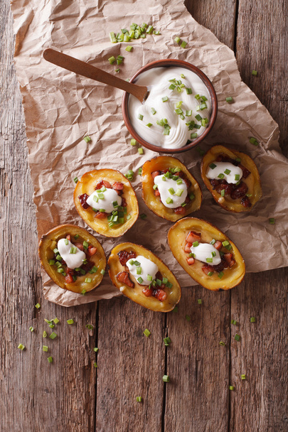 potato skins with cheese, bacon and sour cream on the table. ver - Photo, Image